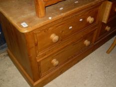 A modern pine dwarf chest of two banks of two drawers