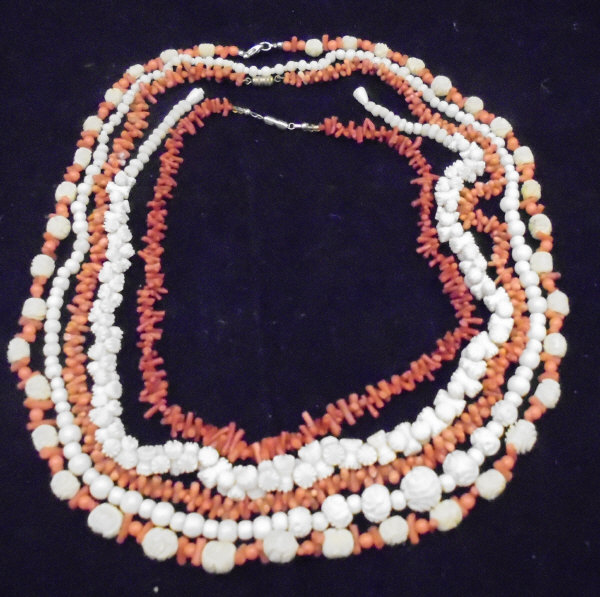 Two beaded coral necklaces together with a further beaded coral and carved bone necklace and two
