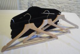 A large collection of wooden and other coat hangers,