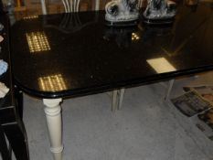 A modern marble top dining table on painted pine base