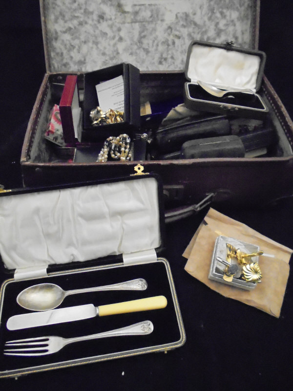 A small suitcase containing various costume jewellery, watches,