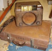 A Bush bakelite cased radio and a leather suitcase