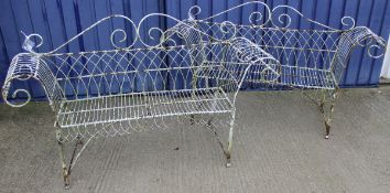 A pair of circa 1900 white painted wrought iron and wire work scroll arm benches