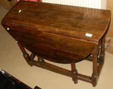 An early 20th Century oak oval gate-leg drop-leaf dining table in the the 17th Century manner