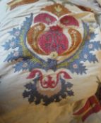 A large cotton throw with embroidered decoration in the form of seed pods and flowers,