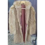 A full length brown fur coat