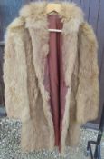 A full length brown fur coat