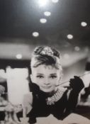 A collection of black and white posters to include Audrey Hepburn as Holly Golightly, etc,