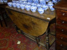 A 20th Century oak oval gate-leg drop-leaf dining table in the 18th Century manner