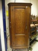 A 19th Century oak hanging corner cupboard with twin fielded panelled door enclosing four shelves