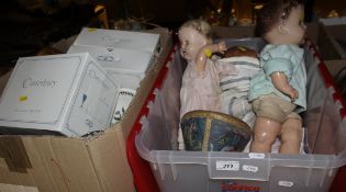 A box containing three various dolls and a drum and a box of various china and glass ware