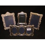 A collection of four various modern silver photograph frames to include one triple frame,