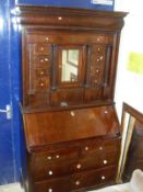 A 19th century continental mahogany bureau cabinet,