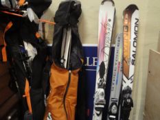 A collection of various ski equipment and clothing including Salomon X Wing Carver skis,