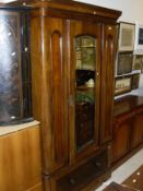 A Victorian mahogany single mirrored door wardrobe with plinth base and drawer