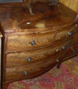 An early 19th Century mahogany bow fronted chest of two short over two long drawers with brass knob