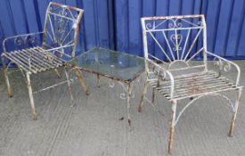A pair of 20th Century painted wrought iron garden chairs with sunburst design together with a