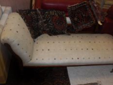 A Victorian faded rosewood frame chaise longue with carved back panel and show frame on turned and