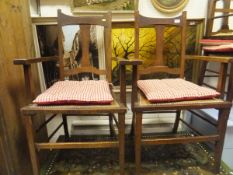 A set of six early 20th Century oak framed dining chairs with brown upholstered seats