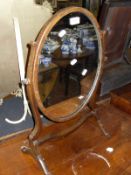 A mahogany shield shaped dressing mirror and a mahogany oval dressing mirror