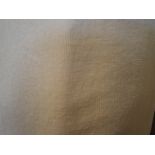 A collection of beige velvet curtains with various swags and pelmets,