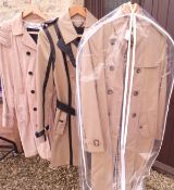 Two Burberry trench coats, one with leather trim,