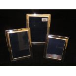 A set of three graduated modern silver photograph frames with beaded edge decoration (by Carrs of
