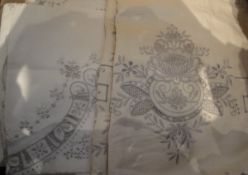 A box containing assorted vintage table linen with cut-out and embroidered decoration