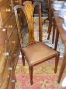 A set of four mahogany and inlaid dining chairs with pinched splat back above a drop-in seat on