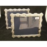 A pair of modern silver photograph frames with embossed C scroll and floral decoration (by Carrs of