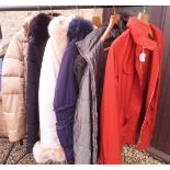 A collection of padded coats with fur collars by various makers to include Millen,