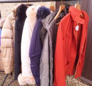 A collection of padded coats with fur collars by various makers to include Millen,