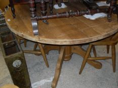 A pine circular breakfast table raised on quadraped legs