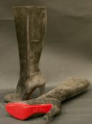 A pair of Christian Louboutin suede boots with red felt bags,