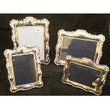 A graduated pair of modern silver photograph frames in the Classical manner with C scroll and