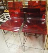 Two modern red perspex and chromed bar stools