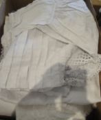 A box containing various Broderie Anglaise and lace Christening Gowns,