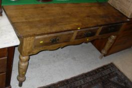 A waxed pine three drawer dresser on turned legs