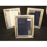 A set of three modern silver photograph frames with reeded and ribboned design (by Carrs of