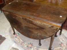 A circa 1800 mahogany oval drop-leaf dining table with single end drawer on turned tapering legs to