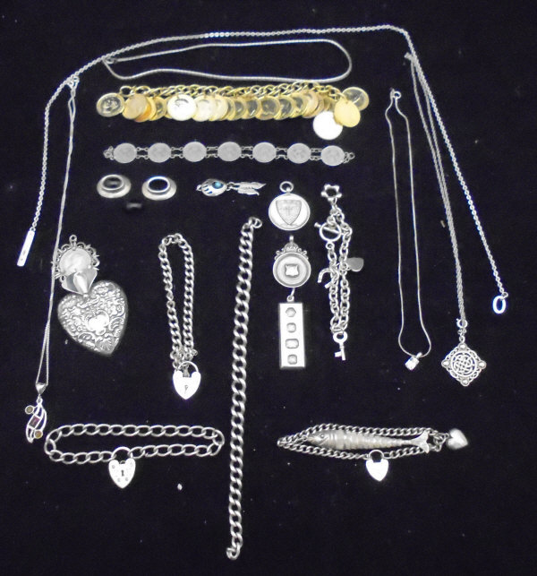 A box containing a collection of jewellery to include silver bracelets with heart shaped locks,