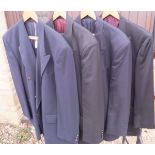 A collection of four black dress jackets,