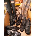 A box of various shoes comprising a pair of Fendi platform heels, patent Burberry heels,