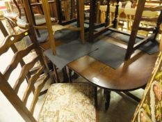 A modern dark oak effect drop leaf dining table together with a set of 4 modern ladder back dining