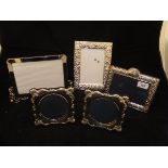 A pair of modern silver photograph frames with embossed C scroll and shell decoration (by Carrs of