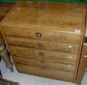 A Heal Furniture Archie Shine design yew wood chest of five long drawers with flush brass handles
