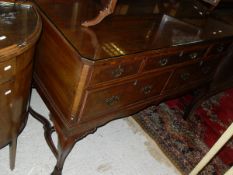 An early 20th Century walnut side table with raised back over three short and two long drawers