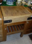 A vintage iron bound butchers block of square form raised on a pitch pine base