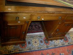 A Victorian gothic revival oak double pedestal desk,