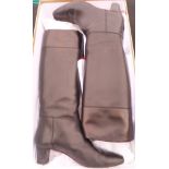 A pair of Christian Louboutin black leather knee high boots, with box and various cloth bags,